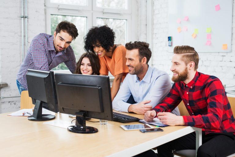 Group of business people working together in office on desktop