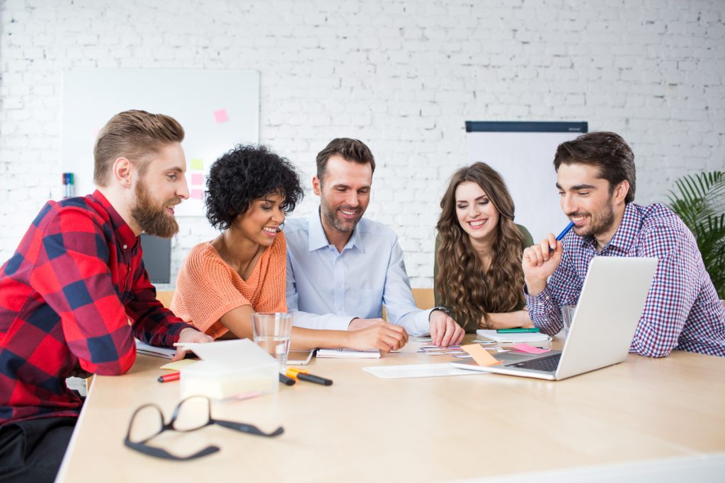 Group brainstorming together during a meeting in the office