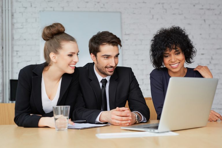 Group of business people looking at laptop