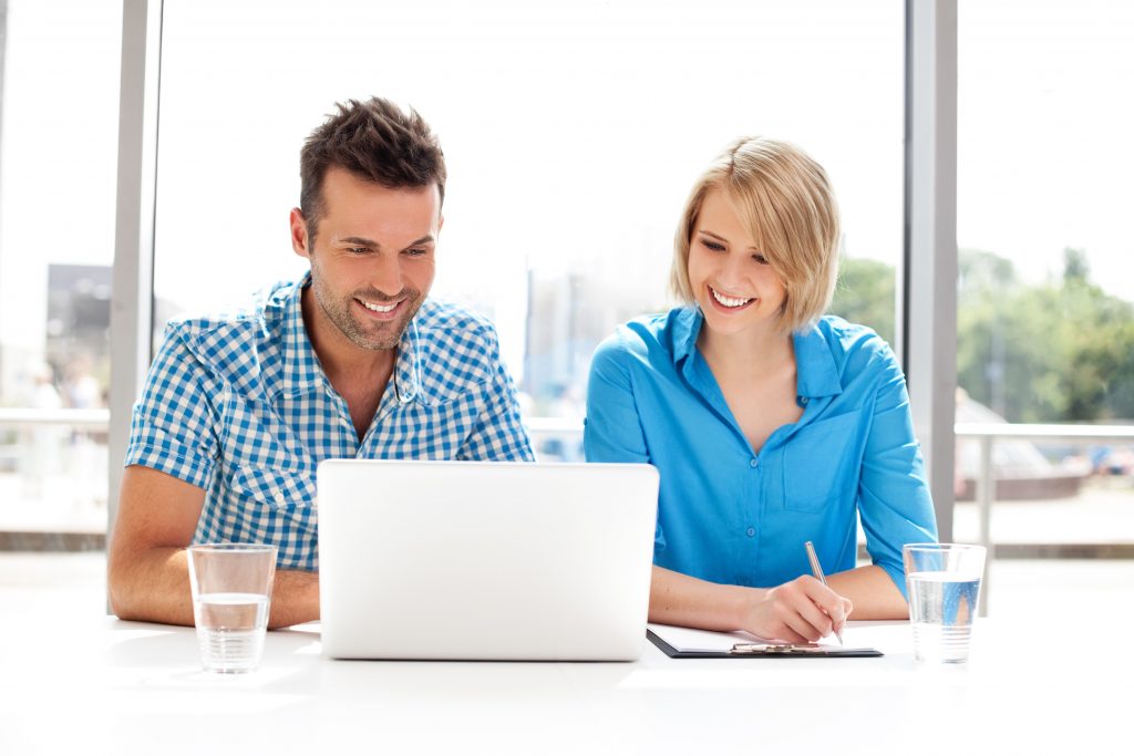 Two colleagues working together on laptop